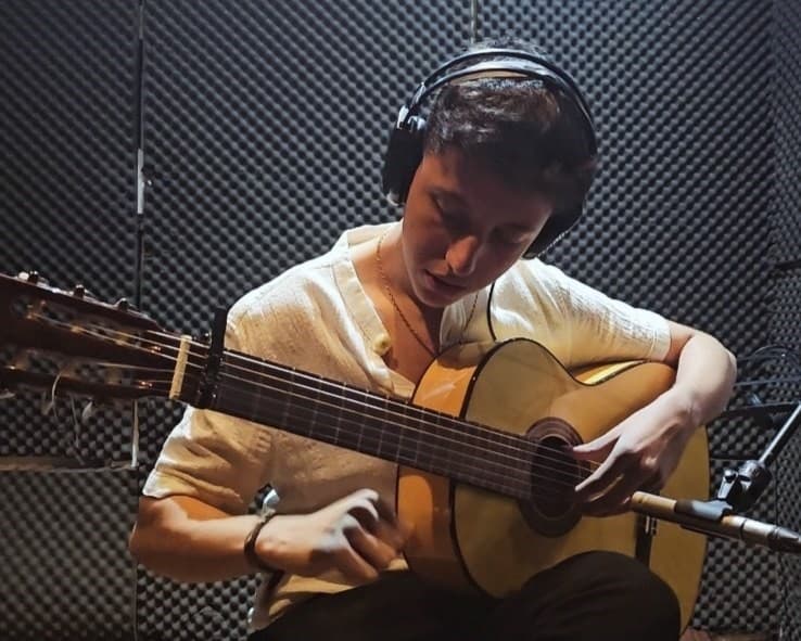 Playing guitar in the studio