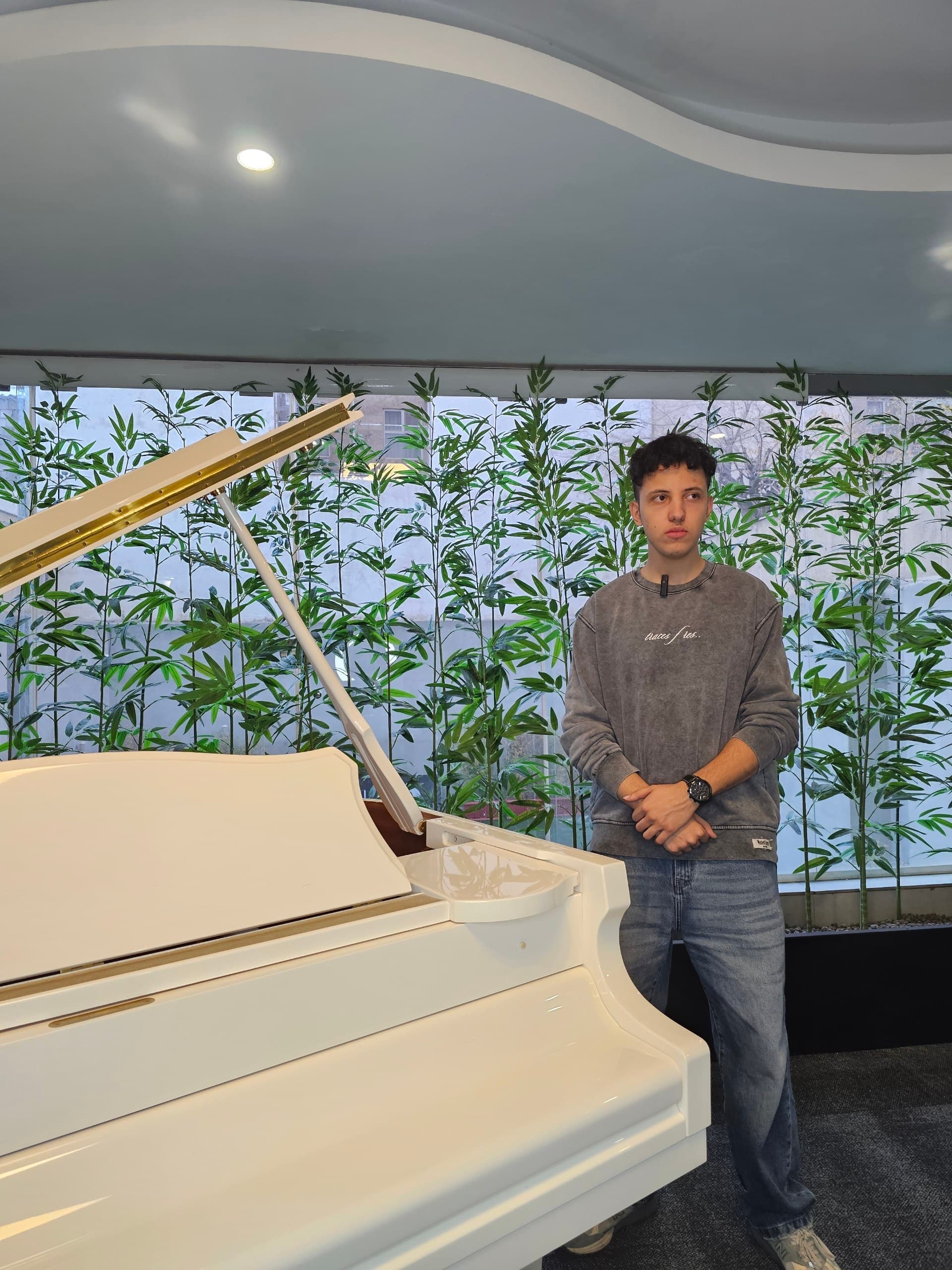 Arash Farahmand beside a piano